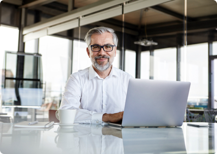 Portrait of executive with laptop and coffee