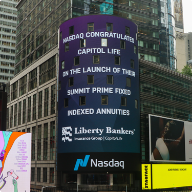 Digital billboard on corner of urban high-rise, message congratulates Captiol Life on annuities launch 